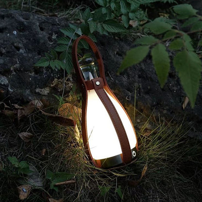 A portable night lamp in the shape of a wine bottle