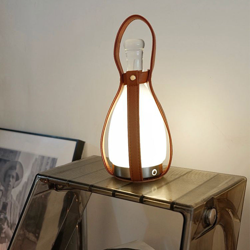 A portable night lamp in the shape of a wine bottle